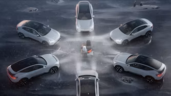 Six white Polestar cars arranged in a circular formation on icy ground with a central ice sculpture.