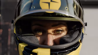 Woman wearing black and yellow Polestar racing helmet