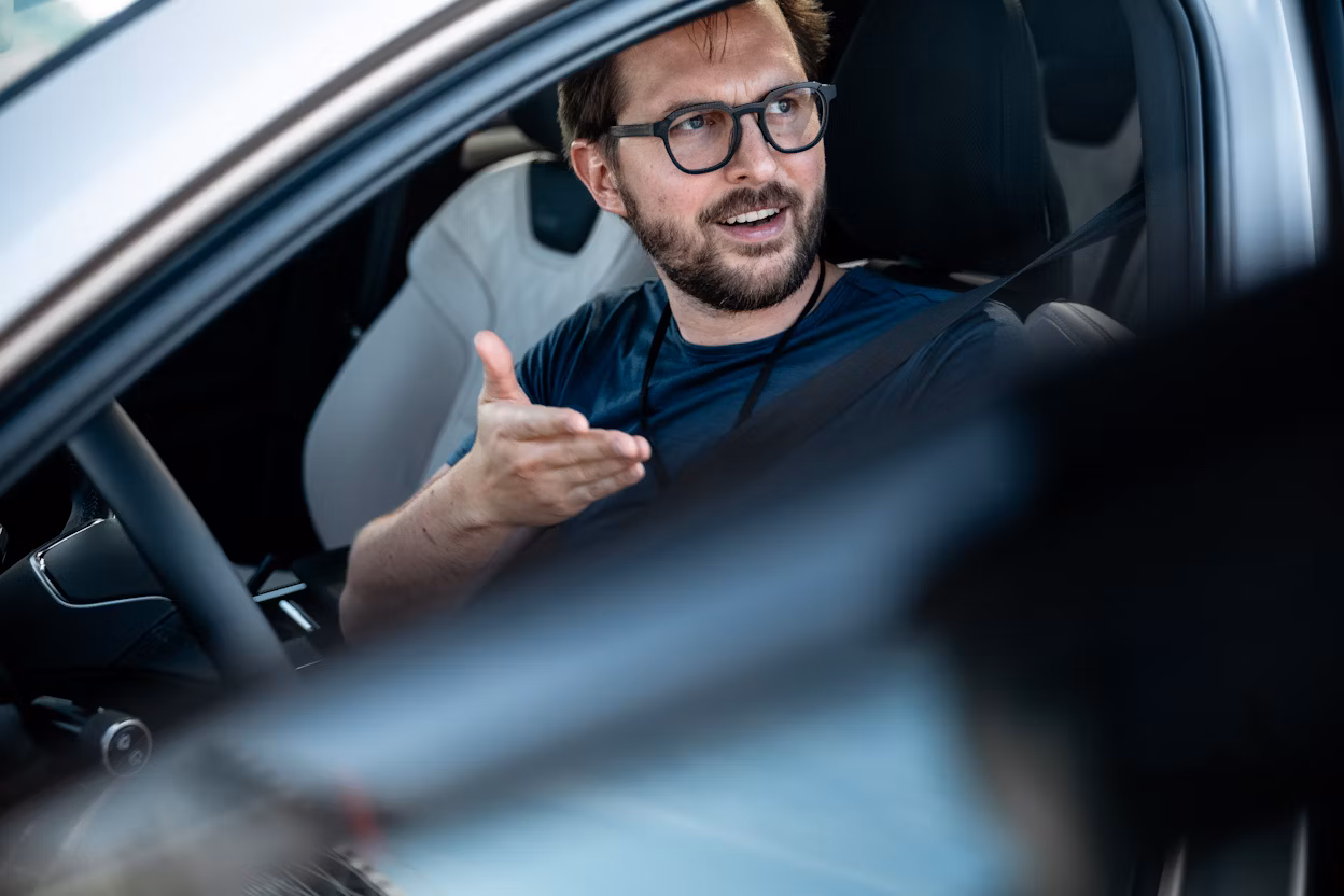 Man sitting inside Polestar 3 with door open