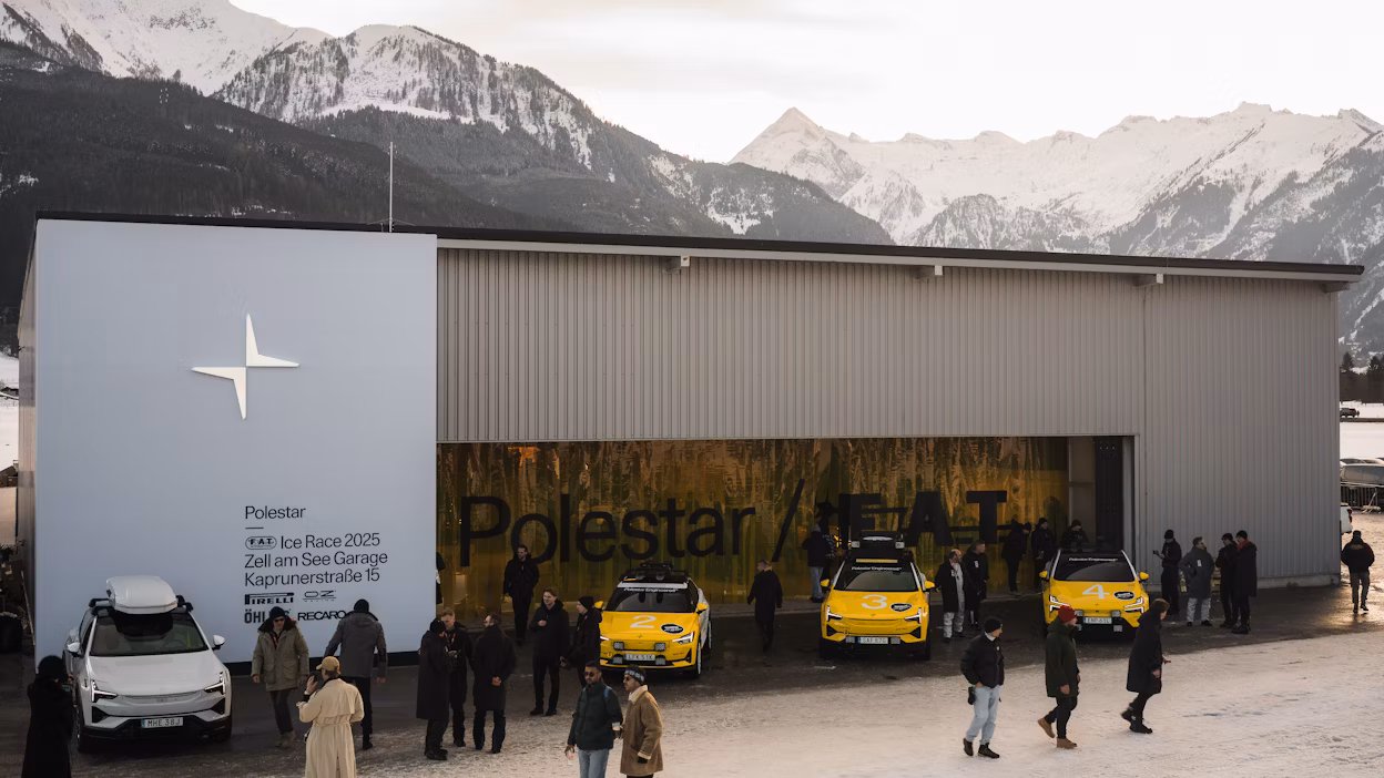 Polestar hangar at ice race event with mountain range in background