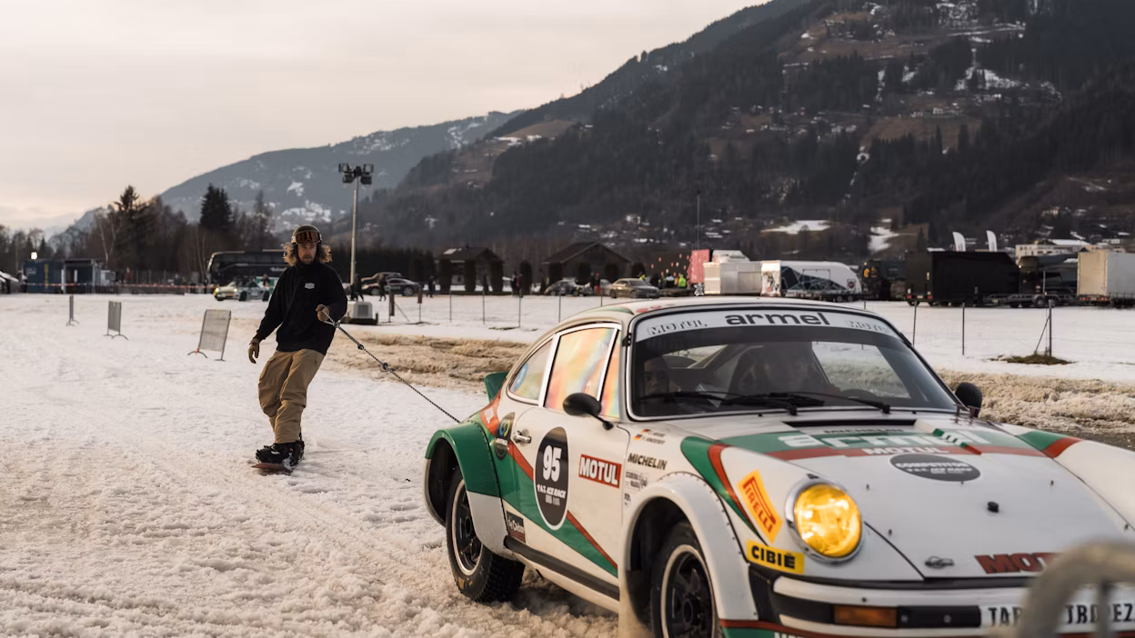 Skier being towed by car around ice track