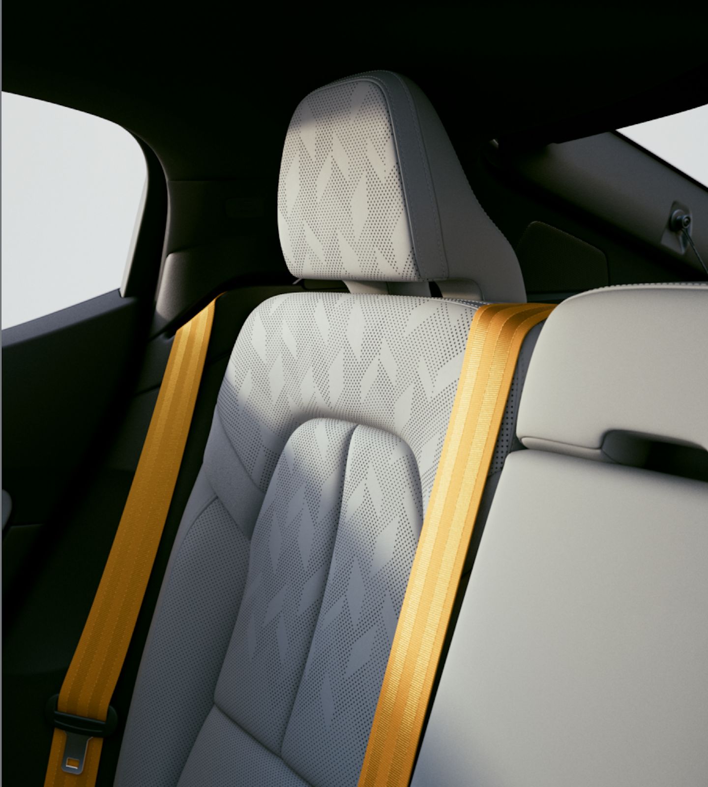 Polestar 2’s rear seats in Zinc upholstery with the Swedish gold seat belt as seen from the front.