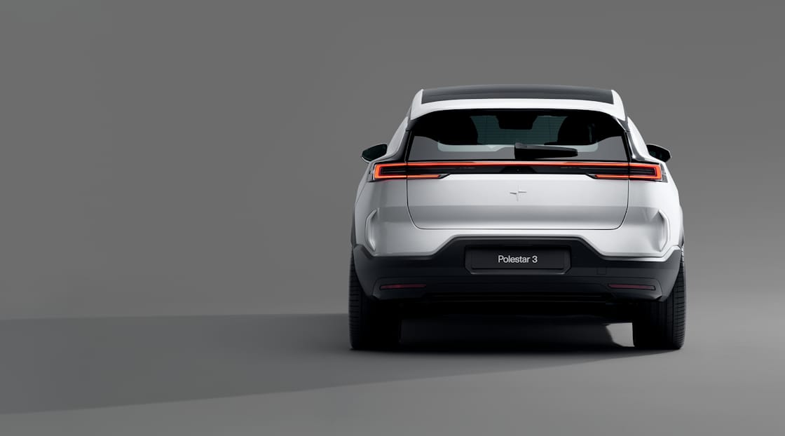 The back of Polestar 3 in Magnesium colour standing in a grey background.