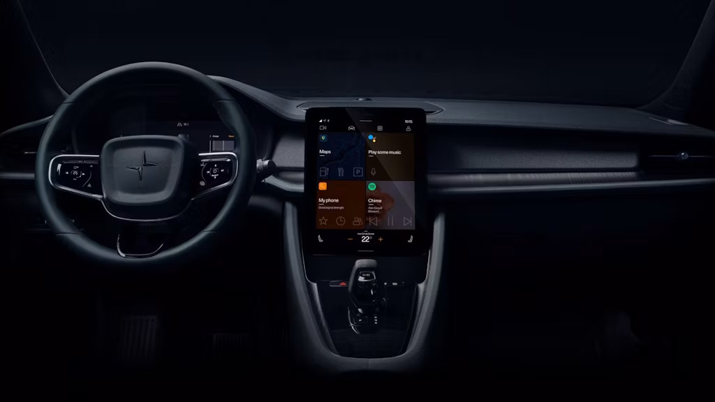 Interior of a Polestar 2 with steering wheel on the left and lit up infotainment in the middle showing the apps Google Maps, Voice assistant, Phone and Spotify