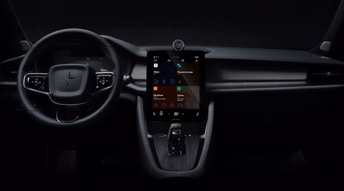Polestar 2’s dashboard area with the steering wheel and centre display against a dark background.